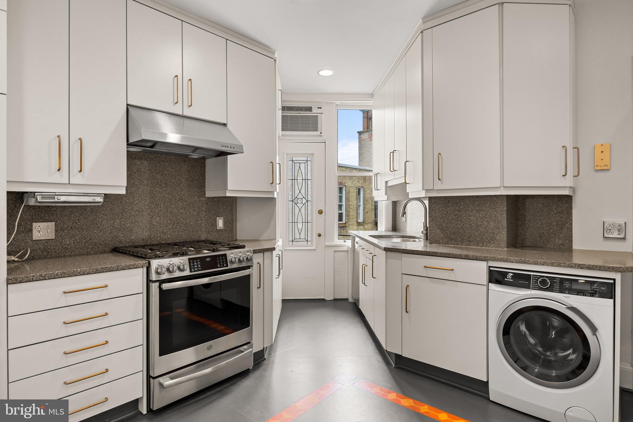 700 Washington Place, Unit 4B Baltimore, MD 21201 - Photo 53 of 67 a kitchen with granite countertop white cabinets and white stainless steel appliances