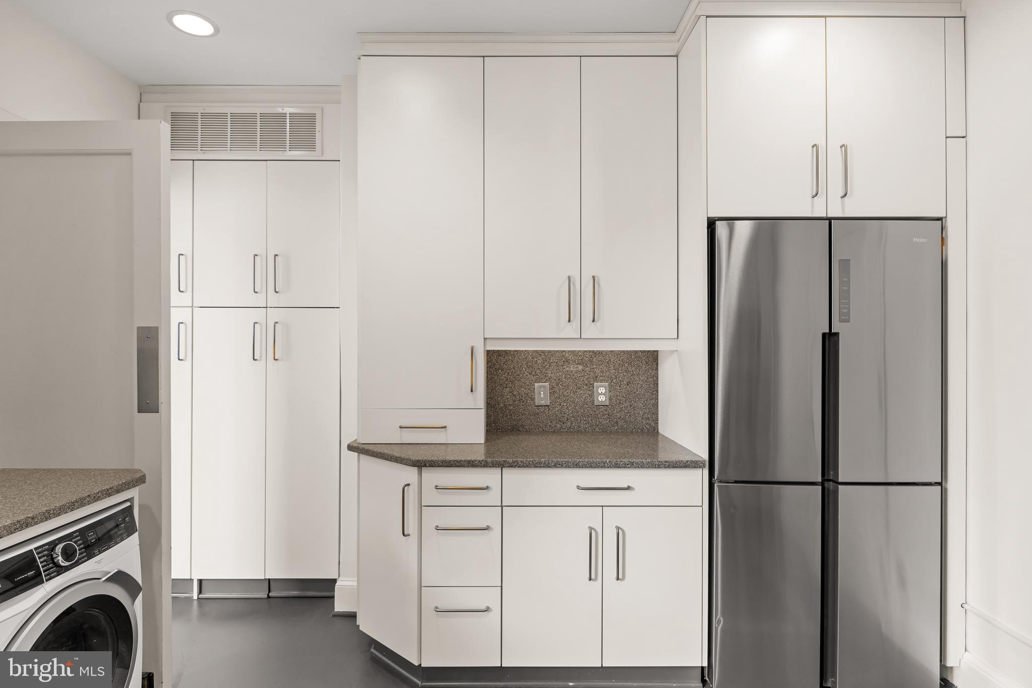 700 Washington Place, Unit 4B Baltimore, MD 21201 - Photo 58 of 67 a kitchen with white cabinets and refrigerator