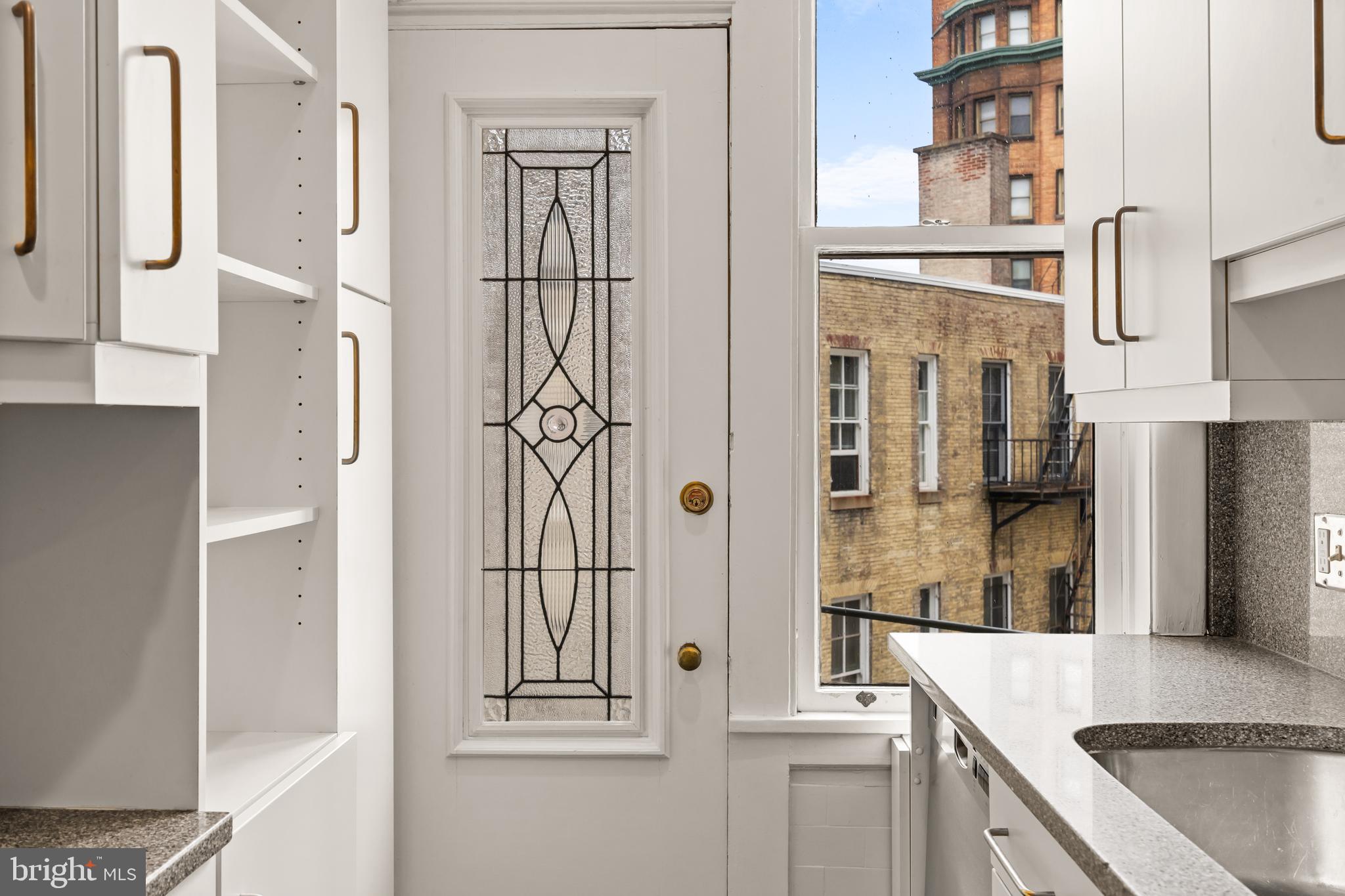 700 Washington Place, Unit 4B Baltimore, MD 21201 - Photo 60 of 67 a kitchen with stainless steel appliances granite countertop a refrigerator and a stove
