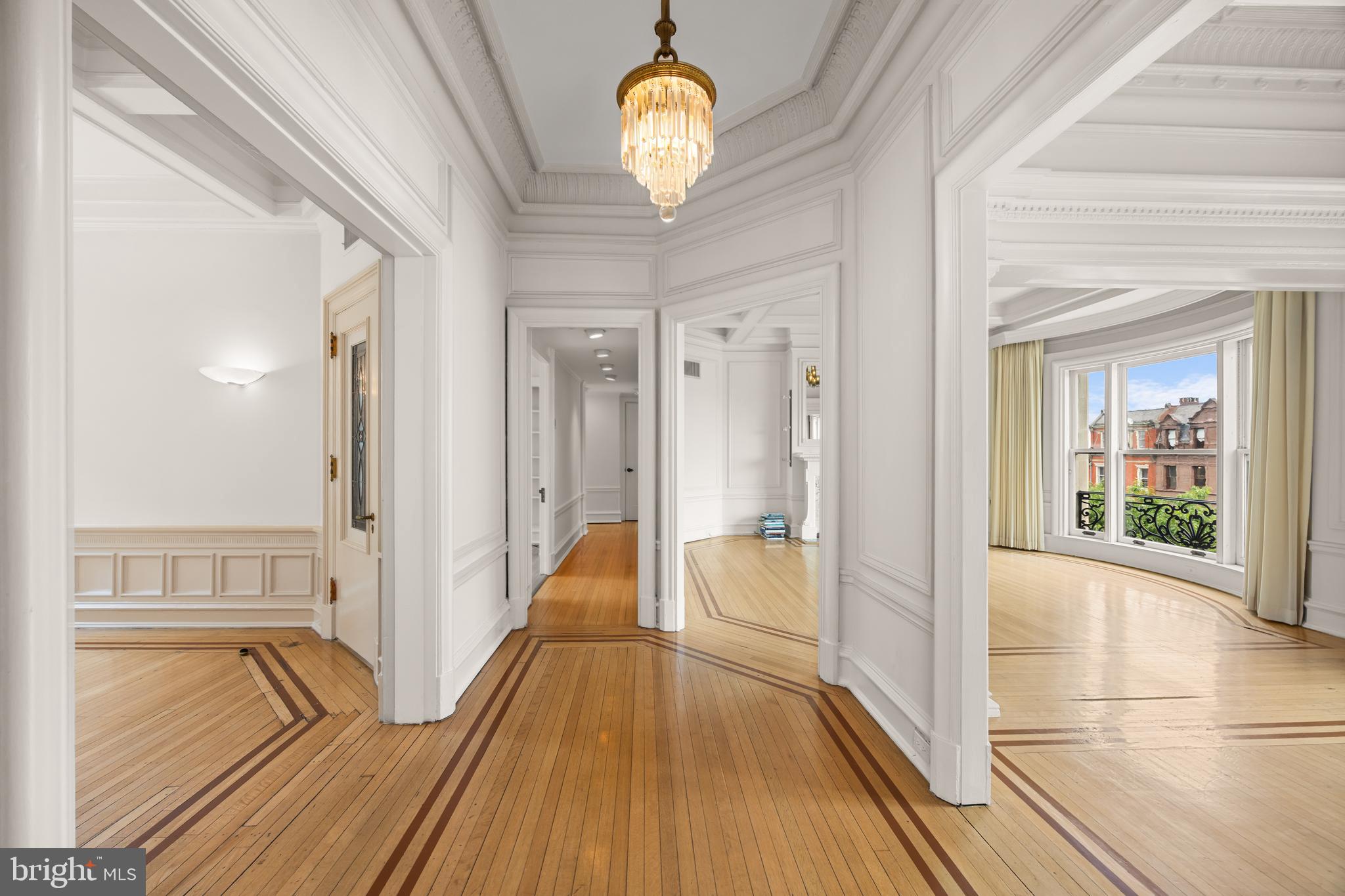 700 Washington Place, Unit 4B Baltimore, MD 21201 - Photo 6 of 67 a view of a hallway with wooden floor and a chandelier