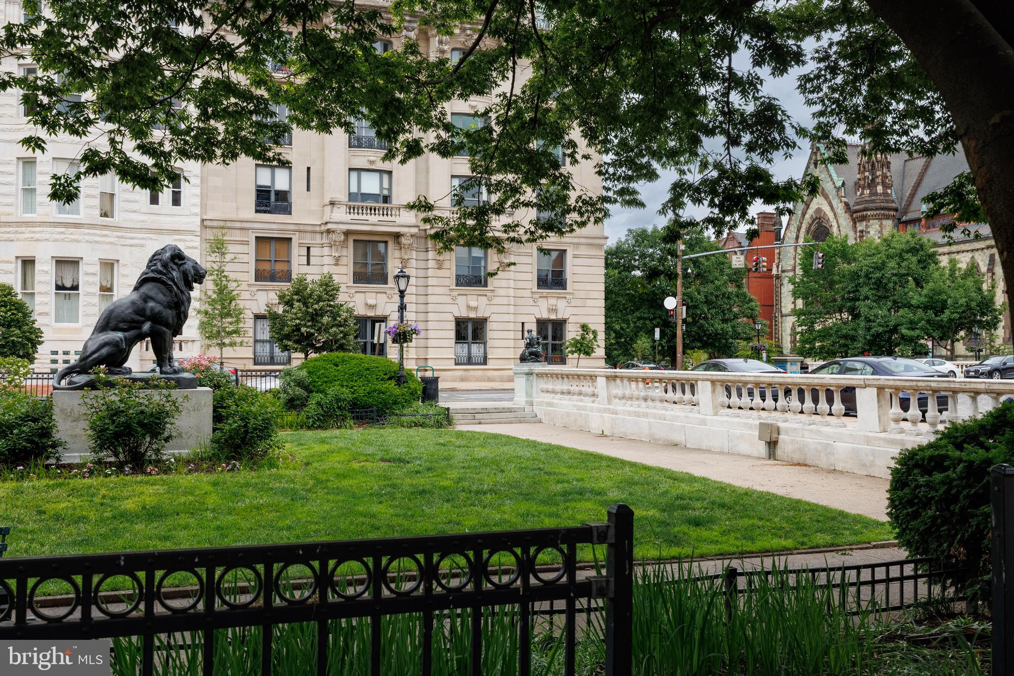 700 Washington Place, Unit 4B Baltimore, MD 21201 - Photo 64 of 67 a view of a white house in front of a big yard plants and large trees