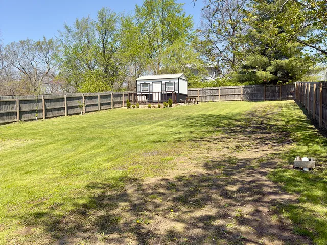 a view of a swimming pool with an outdoor seating and a yard