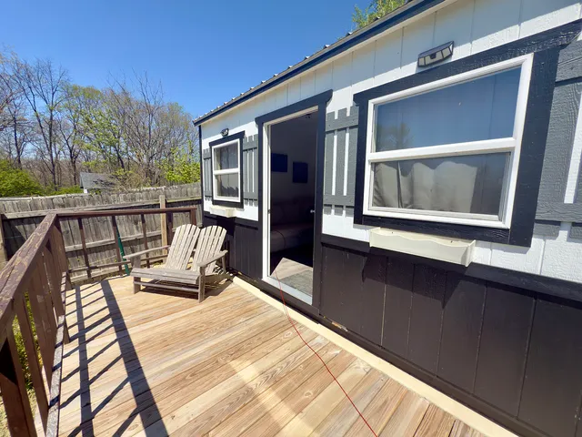 a balcony with wooden floor and furniture