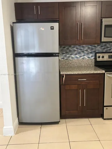 a view of a refrigerator in kitchen