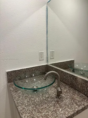 a view of a room with white tiles