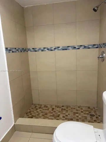 a kitchen with stainless steel appliances a refrigerator a stove a microwave and a sink