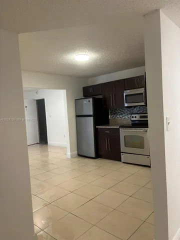 a white toilet sitting next to a shower