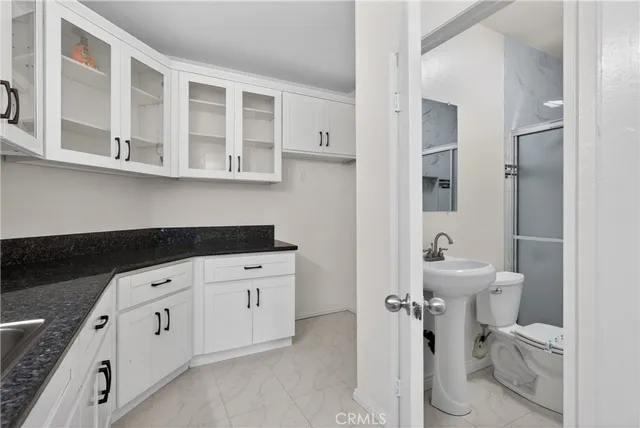 a spacious bathroom with a double vanity sink toilet and shower