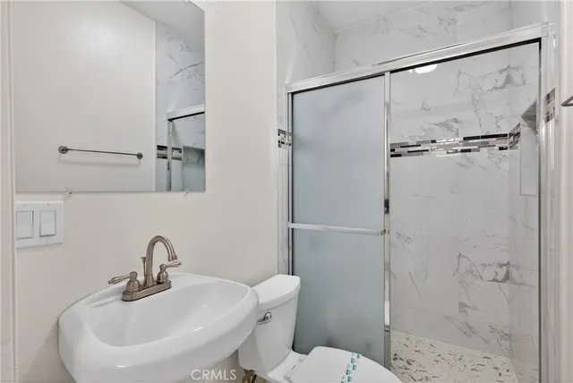 a bathroom with a sink toilet and shower