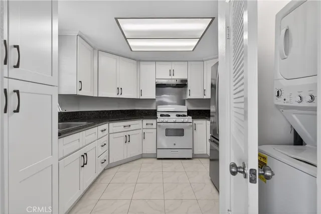a kitchen with white cabinets and white appliances
