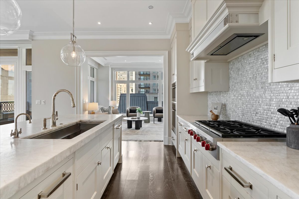 9 West Walton Street, Unit 702 Chicago, IL 60610 - Photo 13 of 38 a kitchen with sink stove and cabinets
