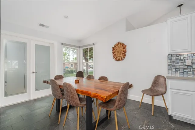 a view of a dining room with furniture and window