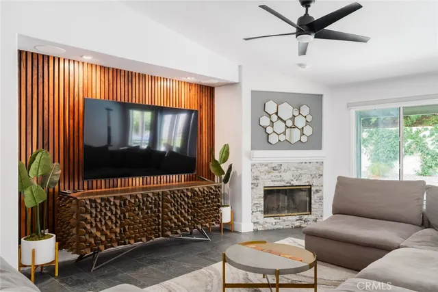 a living room with a couch a fireplace and a window