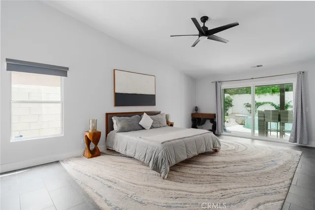 a bedroom with a large bed and a large window