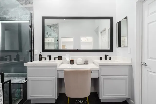 a bathroom with a double vanity sink mirror and