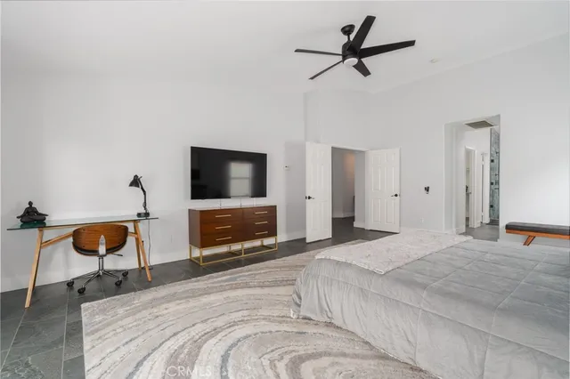 a bedroom with a bed and a flat screen tv