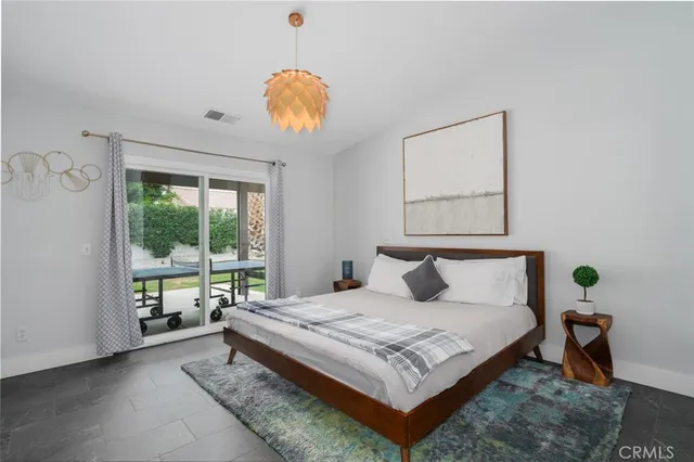 a bedroom with a bed and window