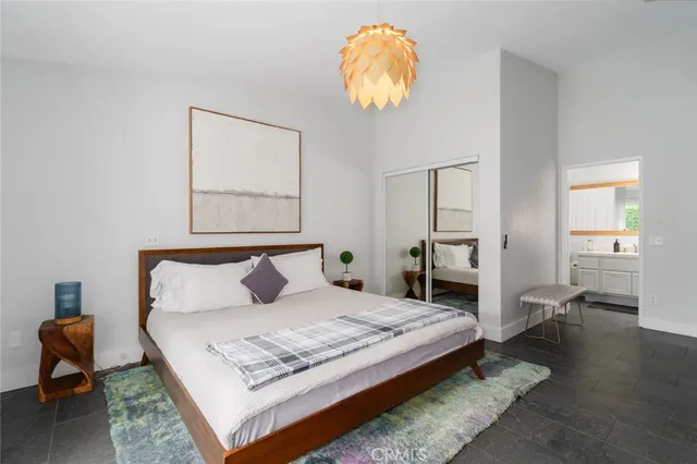 a bedroom with a bed and a chair