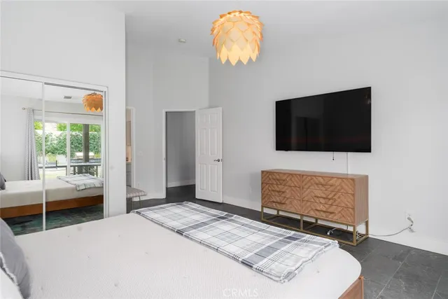 a bedroom with bed and flat screen tv