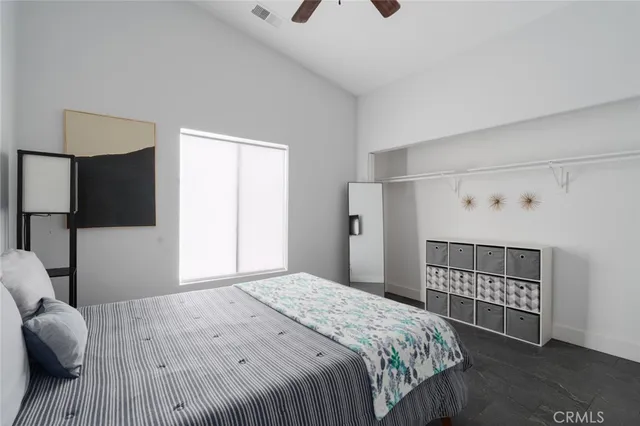 a bedroom with a bed and a tv