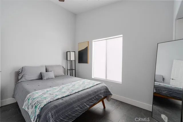 a bedroom with a bed and a window