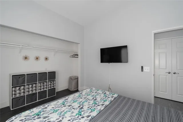a bedroom with a bed and a flat screen tv