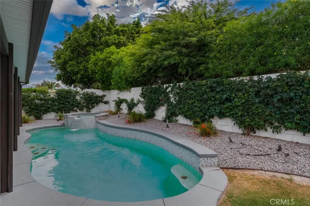 a view of a backyard with wooden fence
