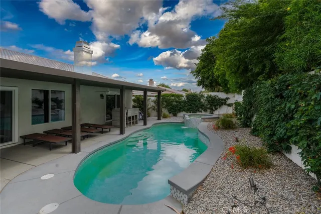 a view of a swimming pool with sitting area