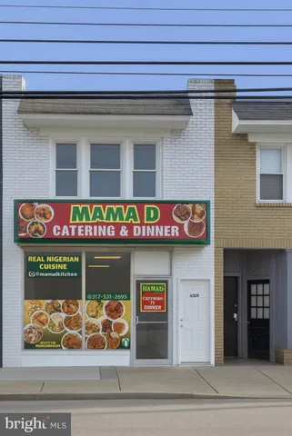 a front view of a building with retail shops