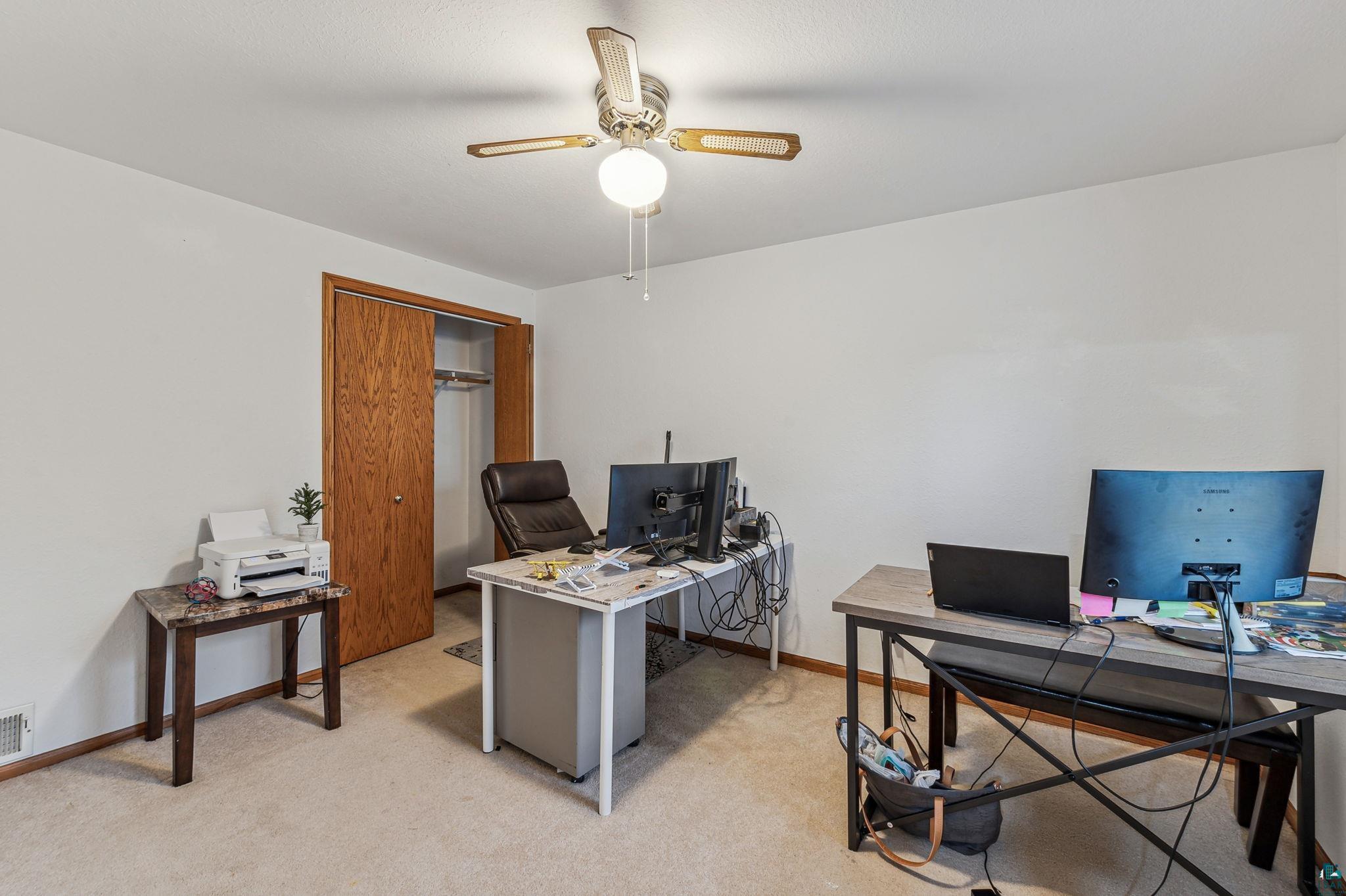 4372 Ugstad Road Hermantown, MN 55811 - Photo 12 of 21 Home office with ceiling fan and light colored carpet