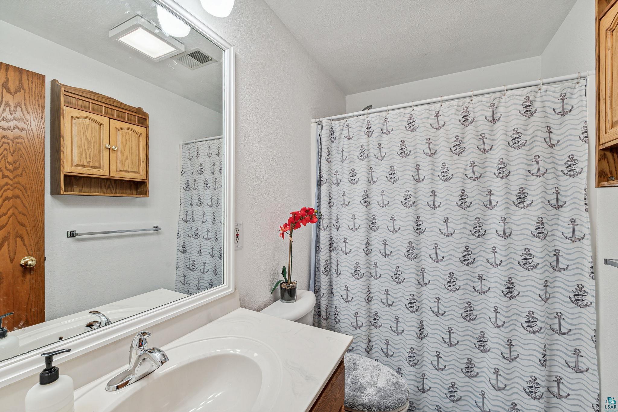 4372 Ugstad Road Hermantown, MN 55811 - Photo 13 of 21 Bathroom with toilet and large vanity