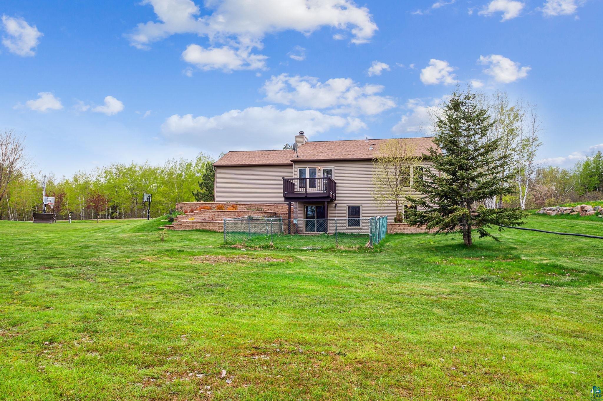 4372 Ugstad Road Hermantown, MN 55811 - Photo 18 of 21 Rear view of property with a lawn