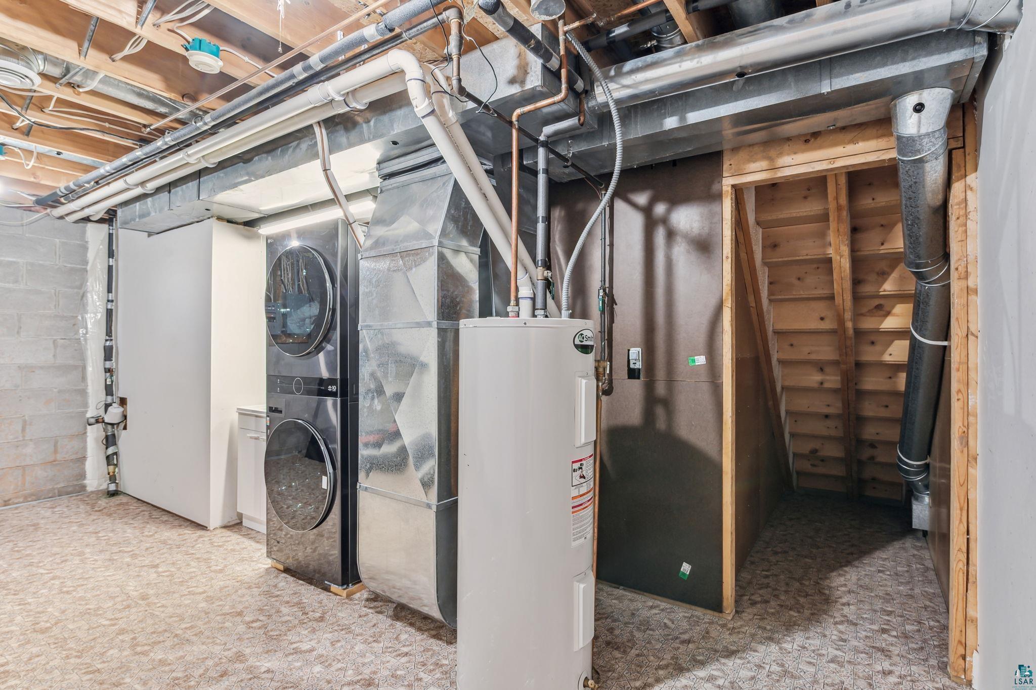 4372 Ugstad Road Hermantown, MN 55811 - Photo 19 of 21 Basement featuring stacked washer / drying machine and water heater