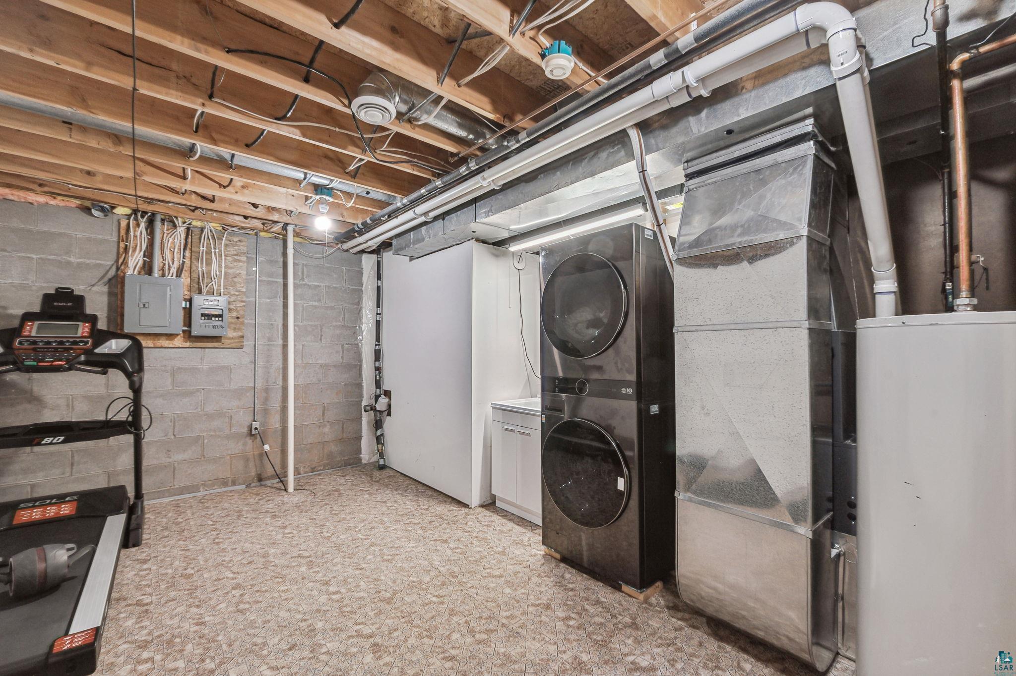 4372 Ugstad Road Hermantown, MN 55811 - Photo 20 of 21 Basement featuring water heater and stacked washer / drying machine