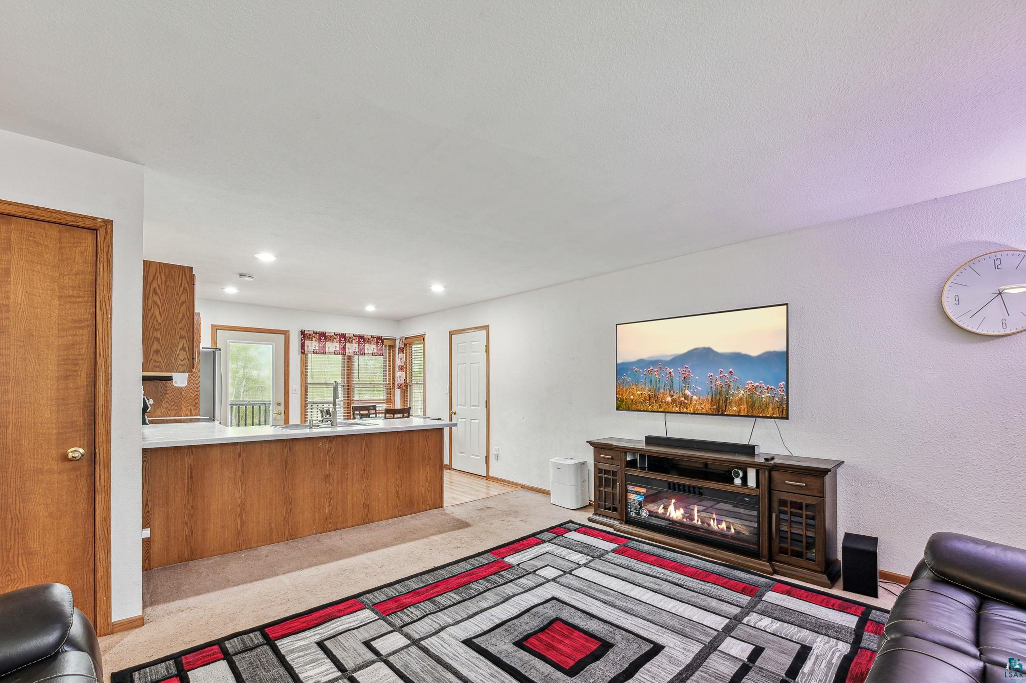 Living room featuring light carpet and sink