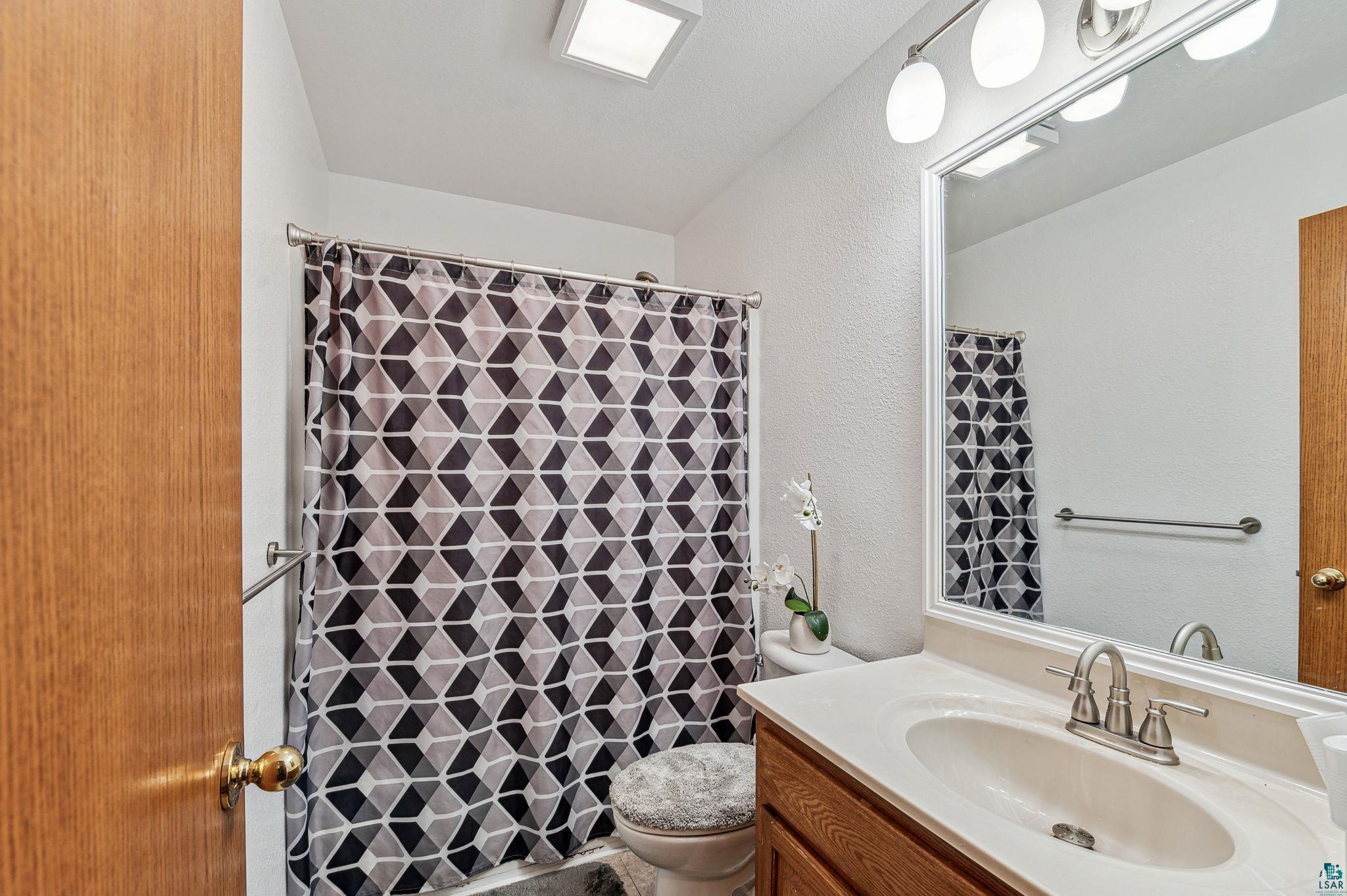 Bathroom with oversized vanity and toilet