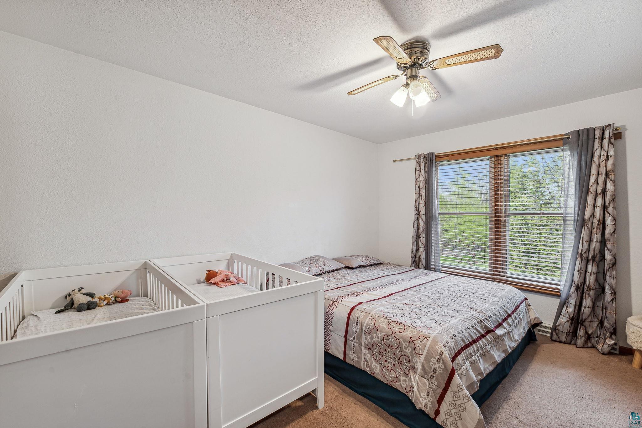 4372 Ugstad Road Hermantown, MN 55811 - Photo 8 of 21 Carpeted bedroom with ceiling fan