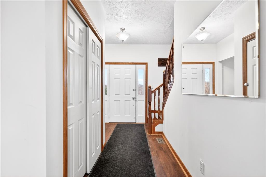 220 Main Road West Alexander, PA 15376 - Photo 16 of 44 a view of a hallway with wooden floor and staircase