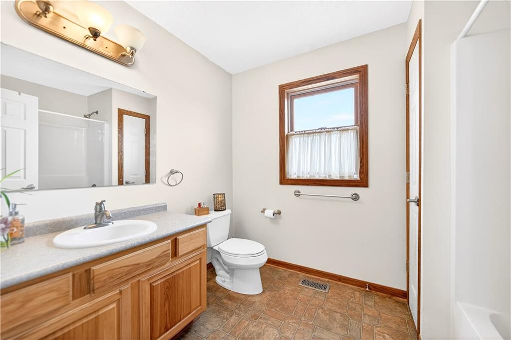 220 Main Road West Alexander, PA 15376 - Photo 21 of 44 a bathroom with a granite countertop toilet a sink a mirror and a window