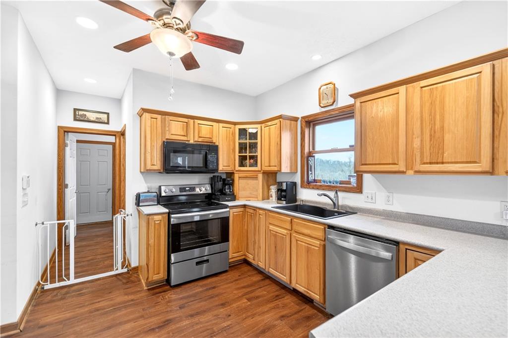 220 Main Road West Alexander, PA 15376 - Photo 6 of 44 a kitchen with stainless steel appliances granite countertop a stove top oven a refrigerator a sink and dishwasher with wooden floor