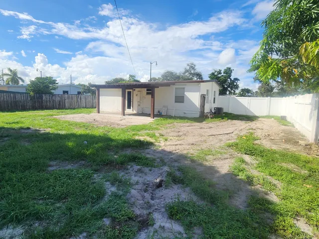 a view of a house with a yard and garage
