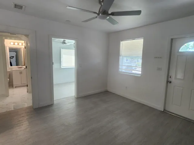 an empty room with windows and closet