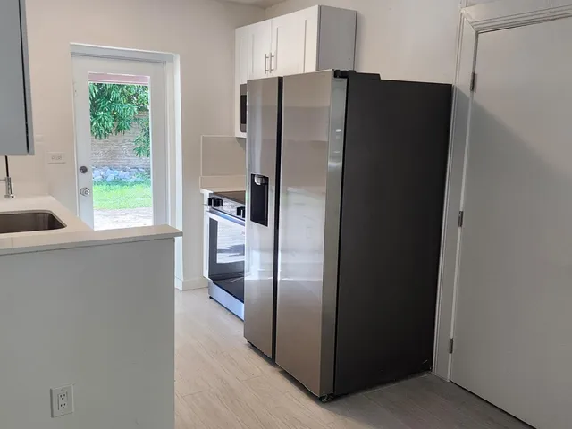 a kitchen with a refrigerator and window