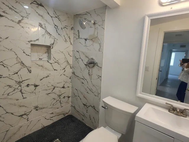 a bathroom with a toilet and a shower curtain