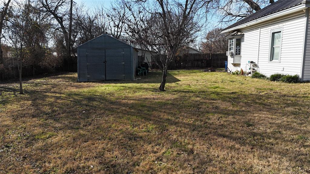 213 West Eldred Street, Unit 2 Burleson, TX 76028 - Photo 15 of 22 a house with trees in front of it