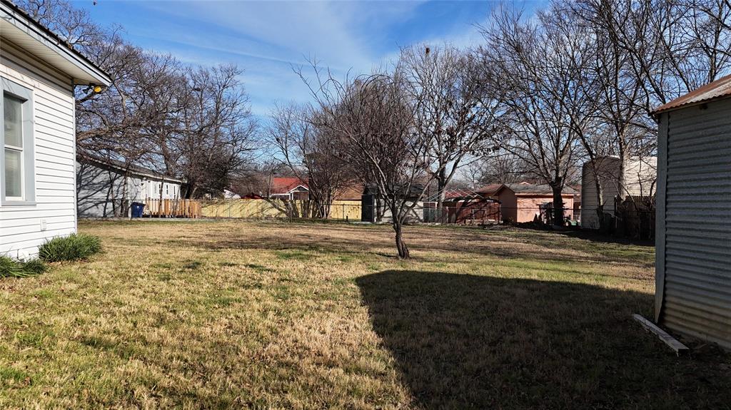 213 West Eldred Street, Unit 2 Burleson, TX 76028 - Photo 19 of 22 a view of road with large trees