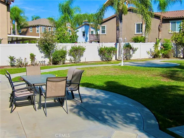 a view of a chairs and table in backyard of the house