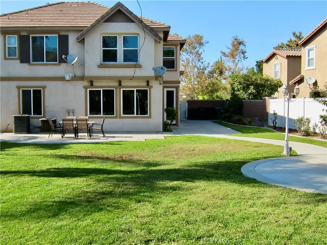 a front view of a house with a yard table and chairs