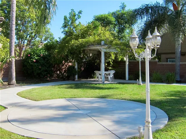 a view of a house with swimming pool and a yard