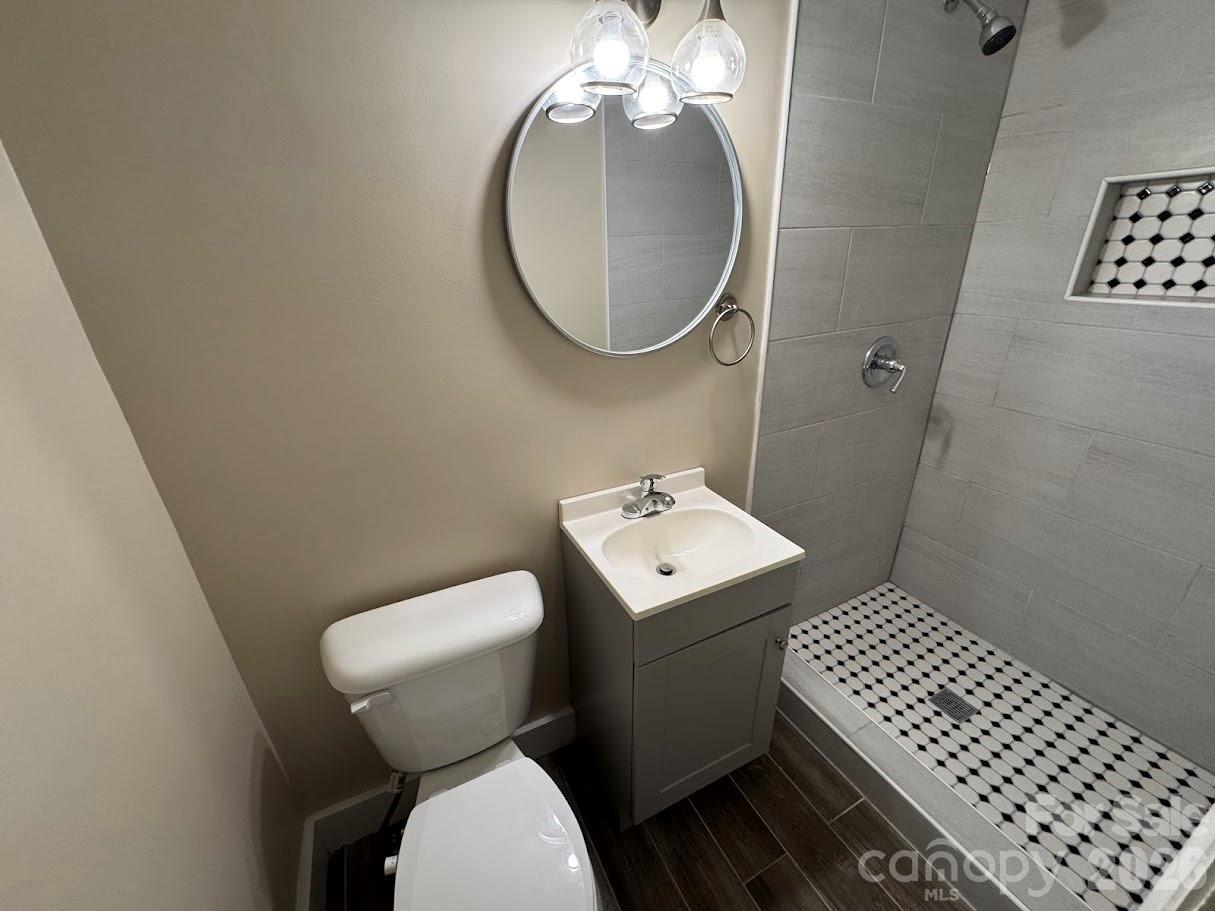 4424 Back Creek Church Road Charlotte, NC 28213 - Photo 12 of 15 a bathroom with a toilet a sink and mirror